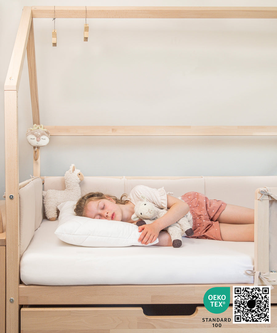 Für alle Schlafpositionen*Das höhenverstellbare Kissen lässt sich individuell auf die Schlafposition von Rücken-, Bauch- und Seitenschläfern abstimmen.|Mädchen liegt in Bett auf höhenverstellbarem Kissen.